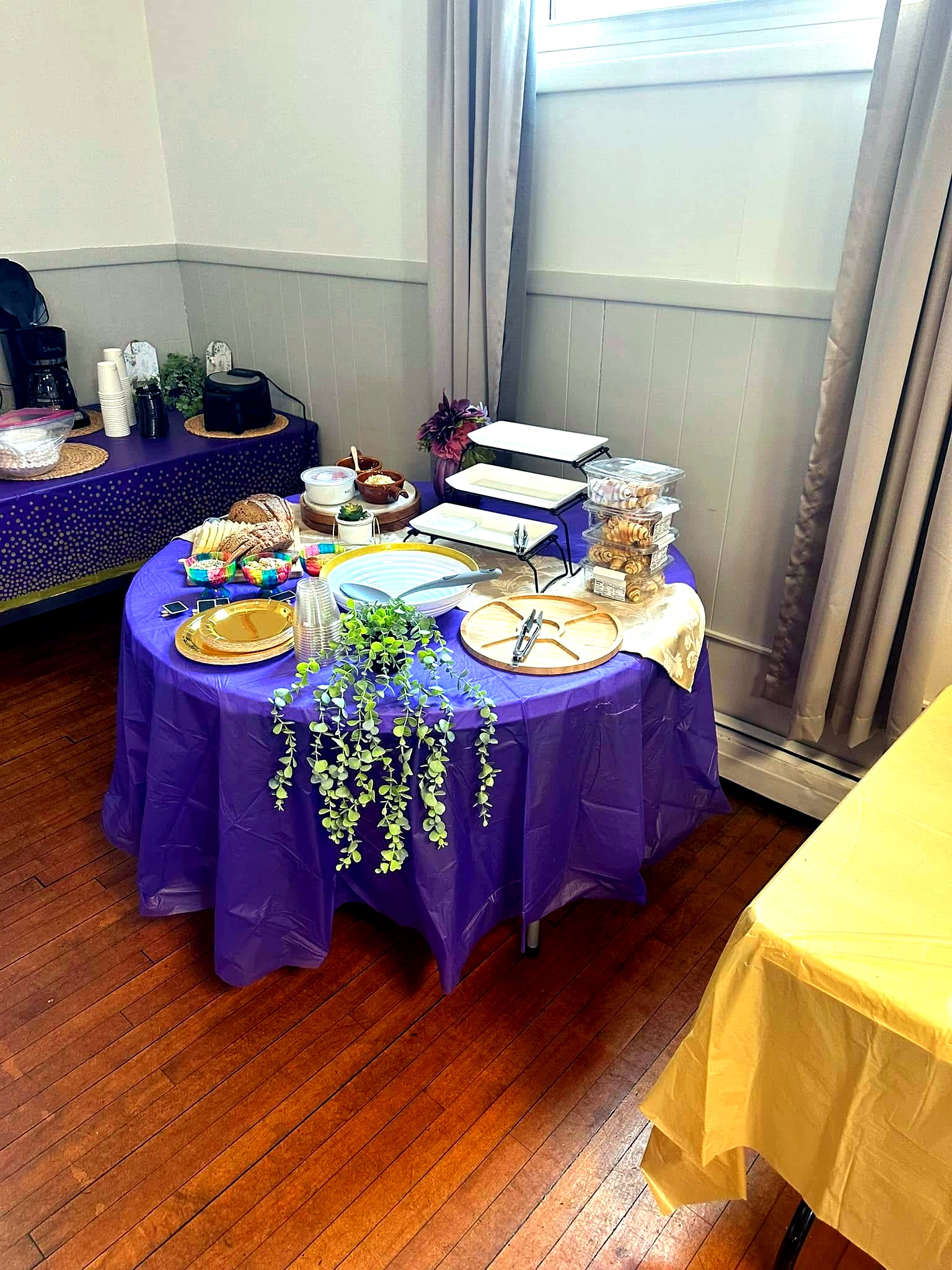 Catering table with tiered trays, bread, fruit and beverage service